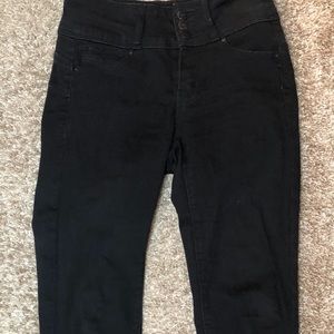 This is a black jean cropped at the ankle.